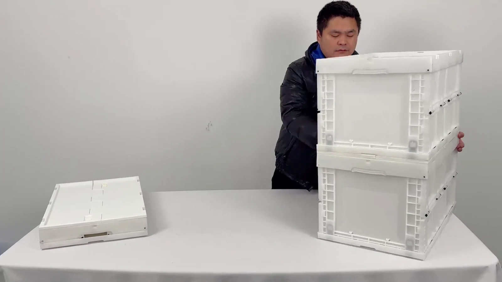 White folding crates being demonstrated on a work table